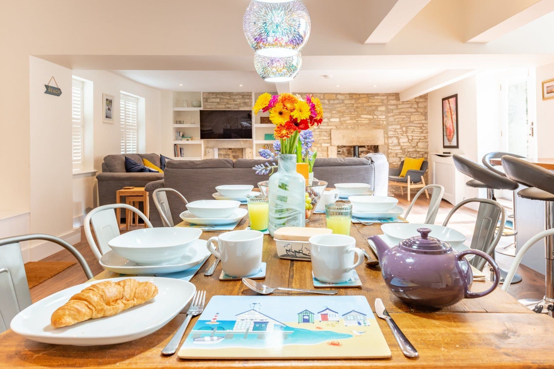 Looking from the dining table towards the sofa and kitchen