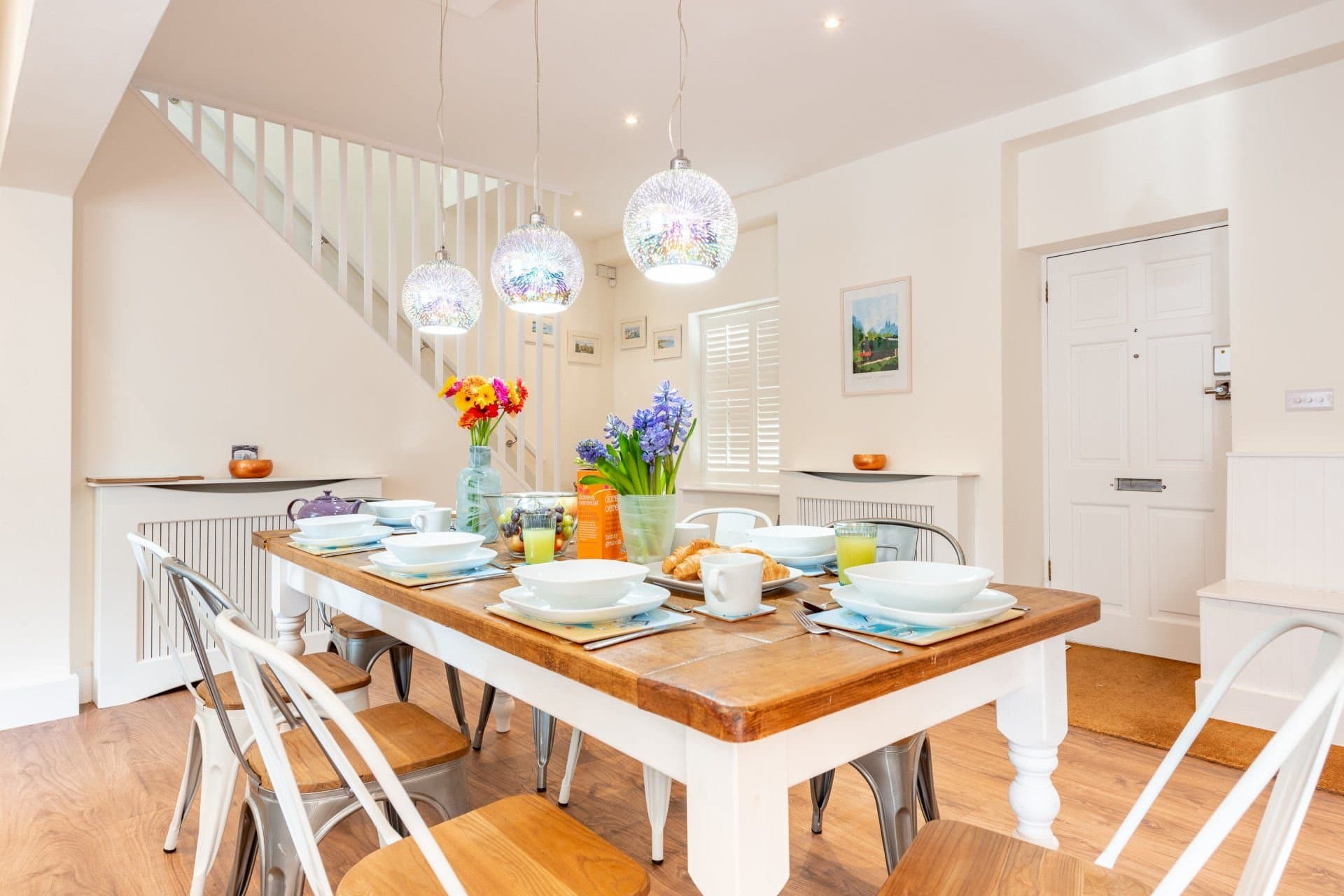 Dining table, breakfast bar stools and the open-plan kitchen