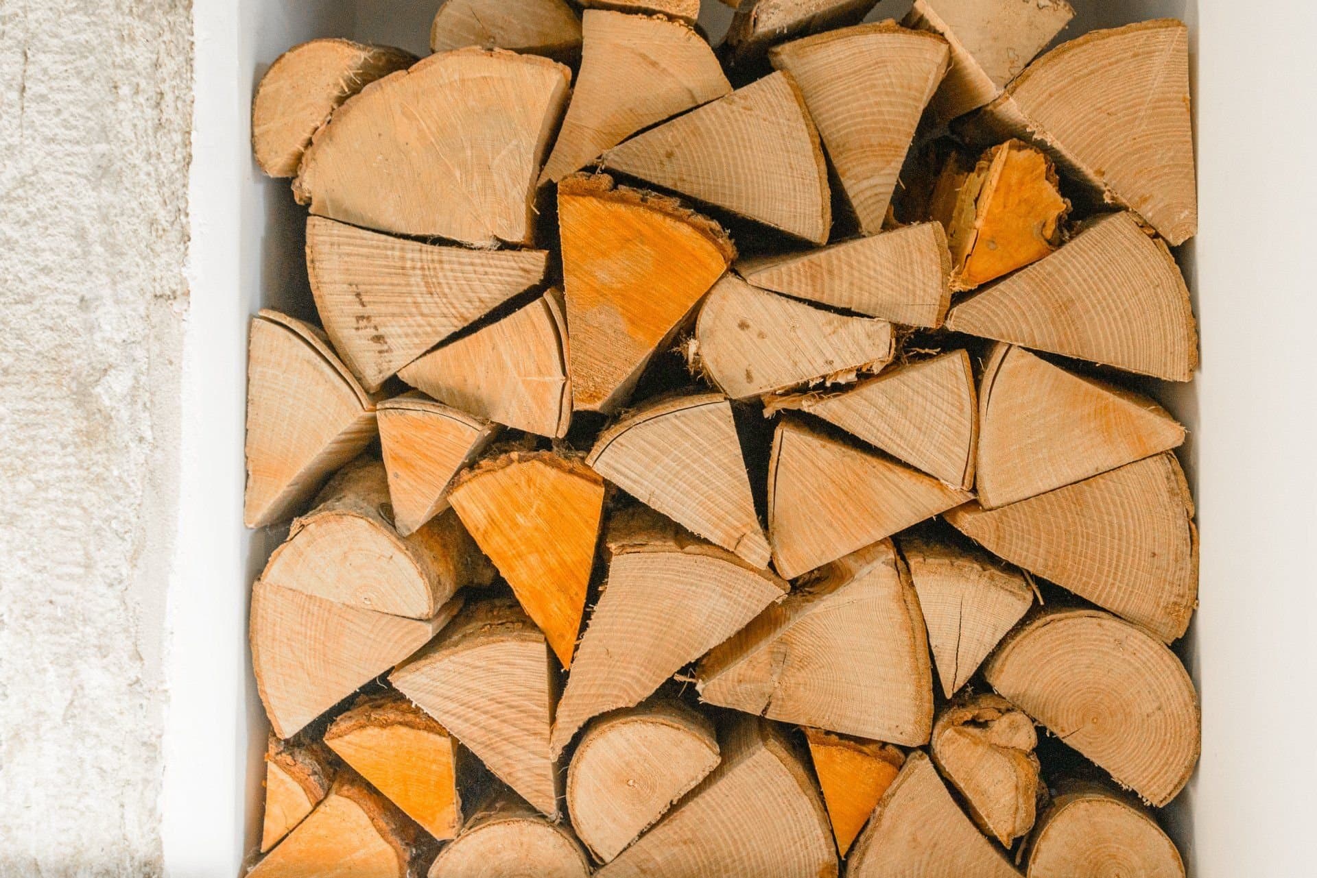 Stacked logs in a alcove beside the fireplace