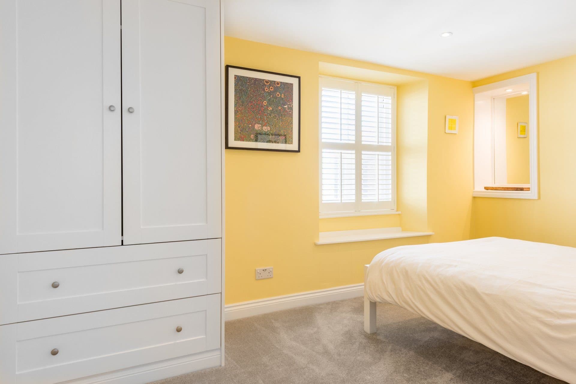 Bedroom with natural light and wooden furniture