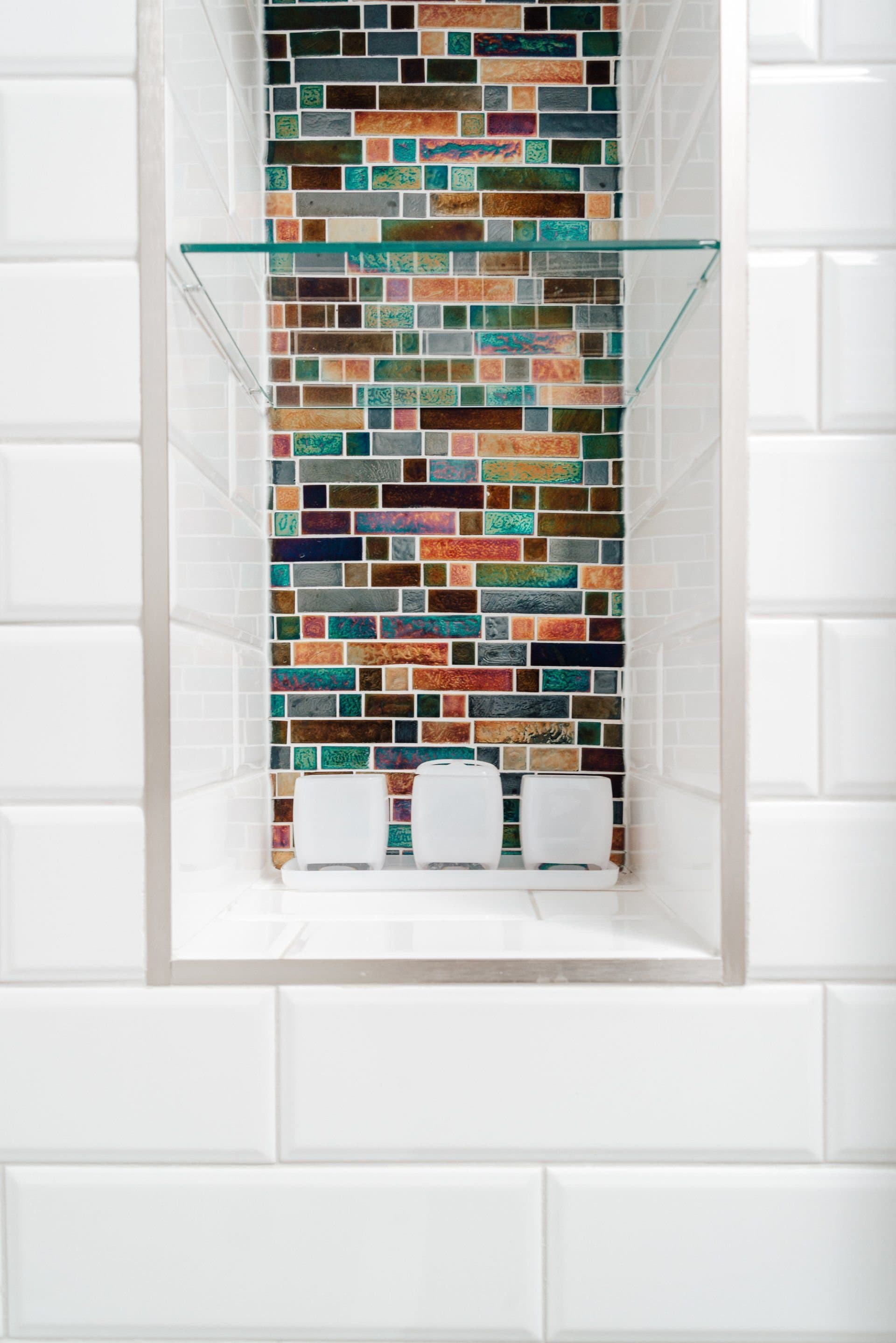 Recessed mosaic tile niche in the bathroom